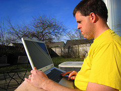 Man using a laptop outside