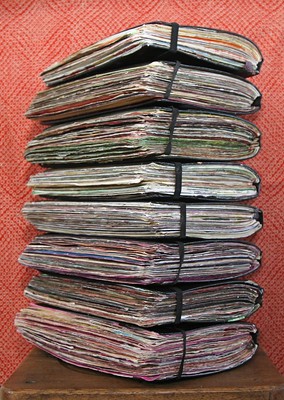 Vertical stack of stuffed-full writing journals