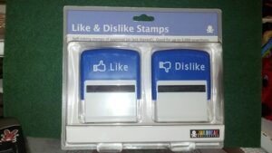 Two self-inking stamps: one stamps a thumbs up with the word Like and the other stamps a thumbs down with the word dislike.