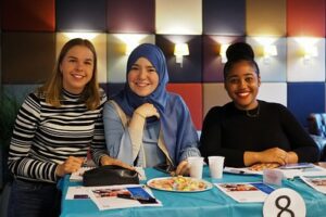 Three college students working on a project together.